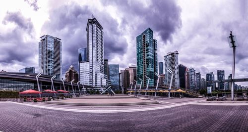 Skyscrapers against cloudy sky