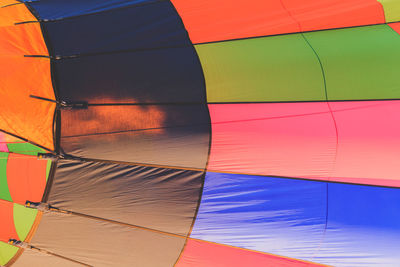 Low angle view of multi colored umbrellas against sky