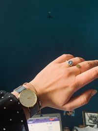 Close-up of hand holding clock