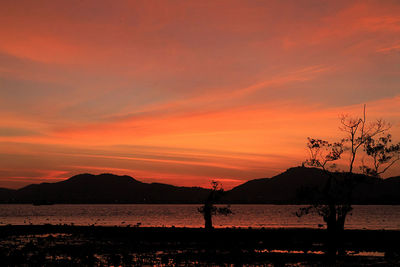 Scenic view of lake against orange sky