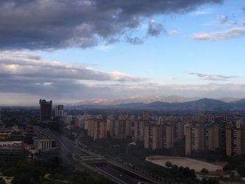 High angle view of city against cloudy sky