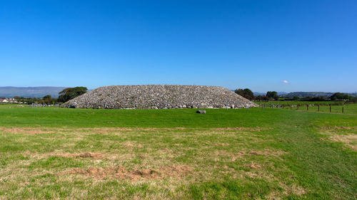 Scenic view of land against clear blue sky