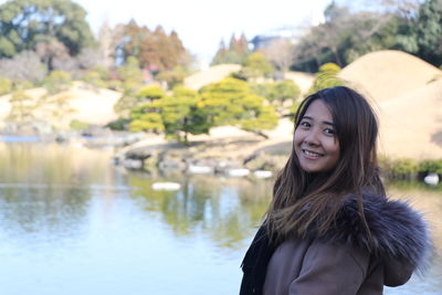 Portrait of a smiling young woman standing outdoors