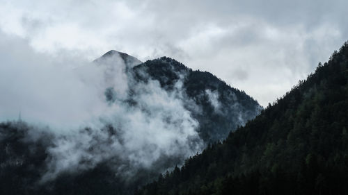 Scenic view of mountains against cloudy sky