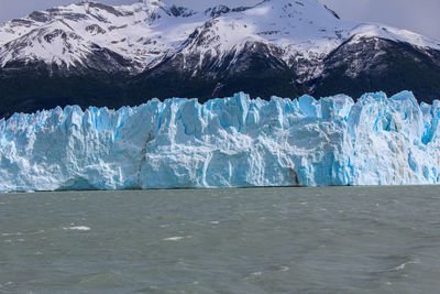 Scenic view of frozen sea against mountain