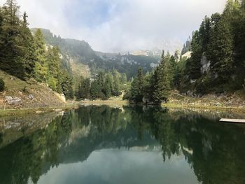 Scenic view of lake and mountains against sky