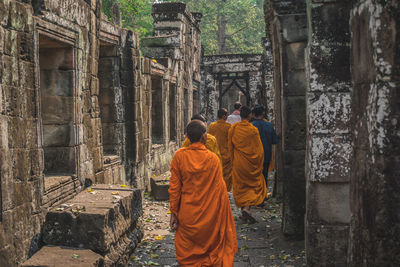 Rear view of people outside temple building