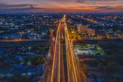 High angle view of illuminated cityscape against sky at night