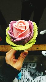 Cropped image of woman holding floral ice cream cone