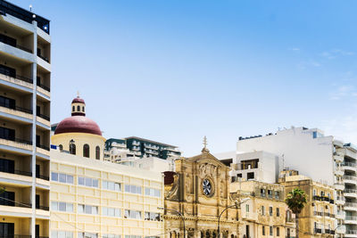 Low angle view of historic buildings in city against clear sky