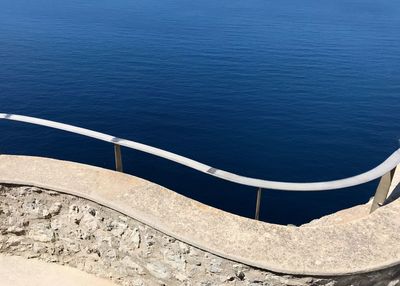 High angle view of railing by sea