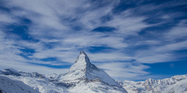 Scenic view of snowcapped mountains against sky