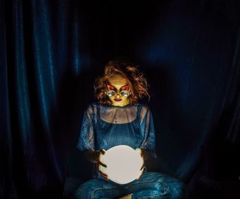 Fortune teller holding illuminated crystal ball