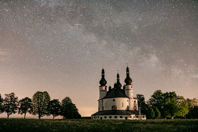 Traditional building against sky at night