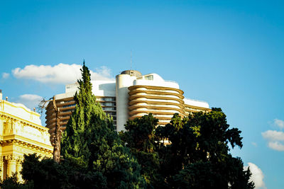 Low angle view of buildings against blue sky