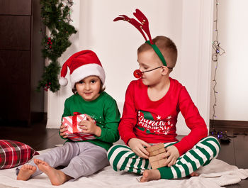 Siblings playing with toys at home