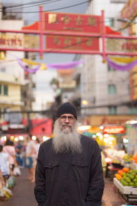 Portrait of man standing in city