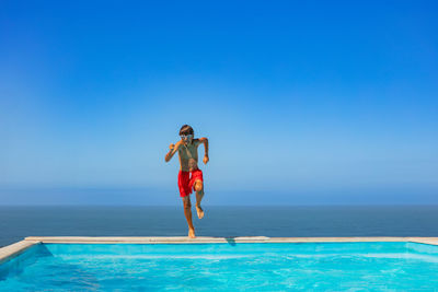 Full length of woman standing in swimming pool