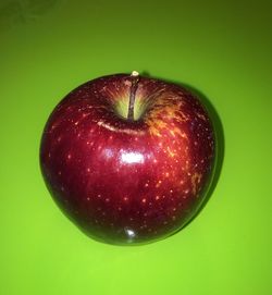 Close-up of red fruit over white background