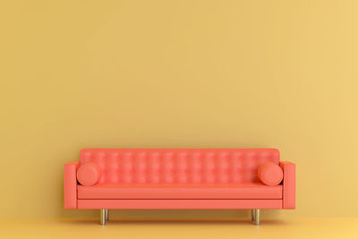 Empty sofa against yellow background