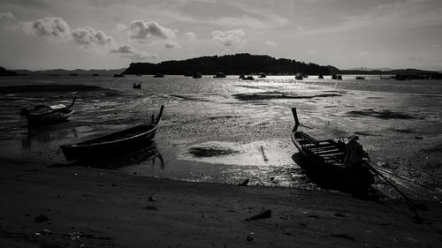 Boats moored on sea against sky