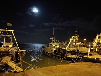 Illuminated commercial dock against sky at night