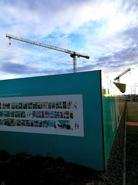Information sign in city against sky