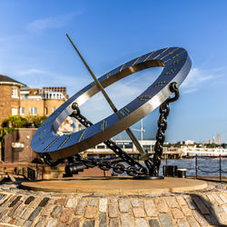 Low angle view of sundial against clear sky