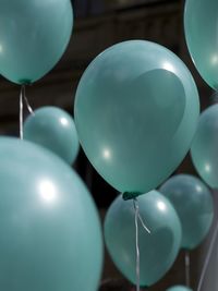 Close-up of turquoise helium balloons at wedding
