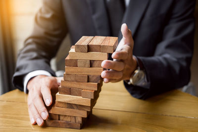 Low section of man working on wooden table
