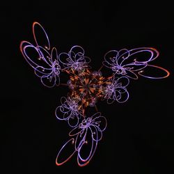 Close-up of illuminated light over black background