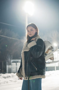 Portrait of young woman standing against sky