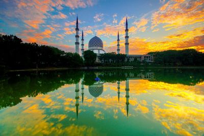 Reflection of building in lake at sunset