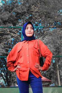Portrait of woman standing in rain during winter