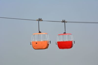 Overhead cable cars against clear sky