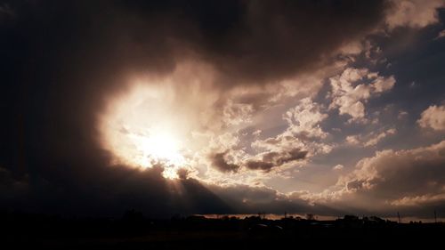 Scenic view of silhouette field against sky during sunset