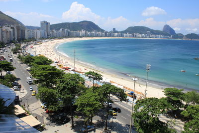 High angle view of sea and city against sky