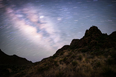 Scenic view of mountains against sky at night