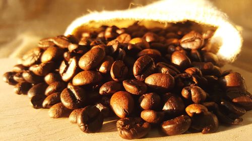 Close-up of roasted coffee beans on table