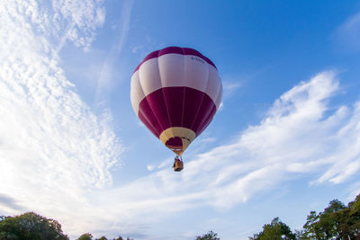 Low angle view of hot air balloon against blue sky