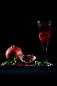 Close-up of wineglass against black background