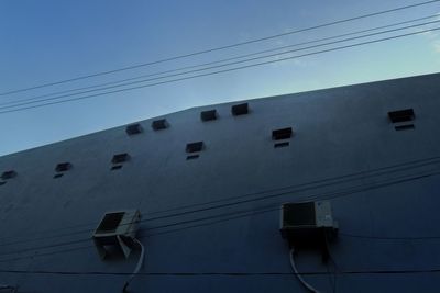 Low angle view of cables against blue sky