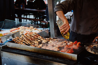 Man working at barbecue grill in restaurant