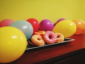 Close-up of multi colored balloons on table