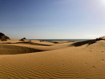 Scenic view of desert against clear sky