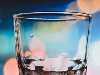 Close-up of empty drinking glass against sky