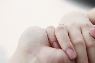 Cropped image of couple holding hands