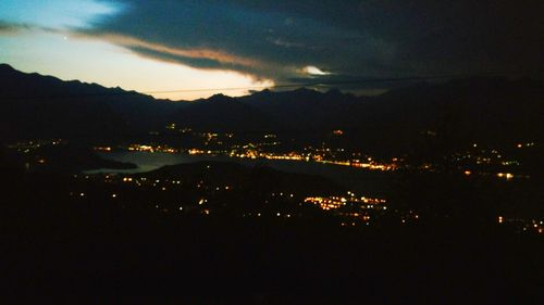 Aerial view of illuminated city against sky at night