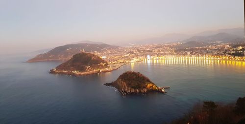High angle view of sea and bay against sky