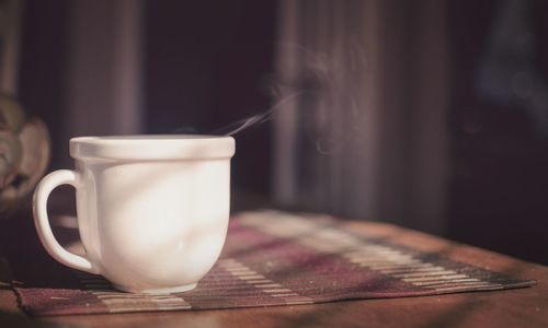 Close-up of hot tea cup on table